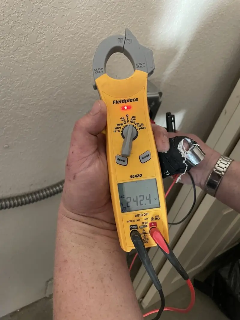 Voltage testing with clamp meter during Recessed Lighting Installation in Roxborough Park